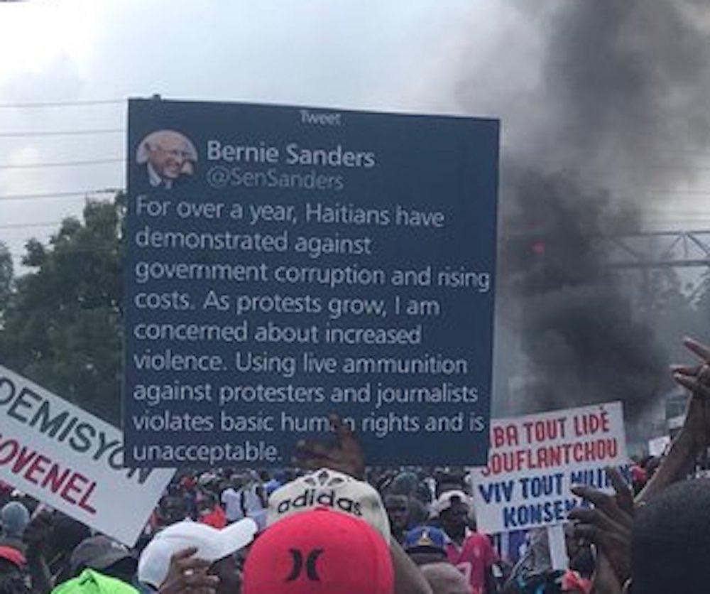 Haitian protesters are holding up a giant Bernie Sanders tweet about their human rights as police repress their demonstrations against corruption