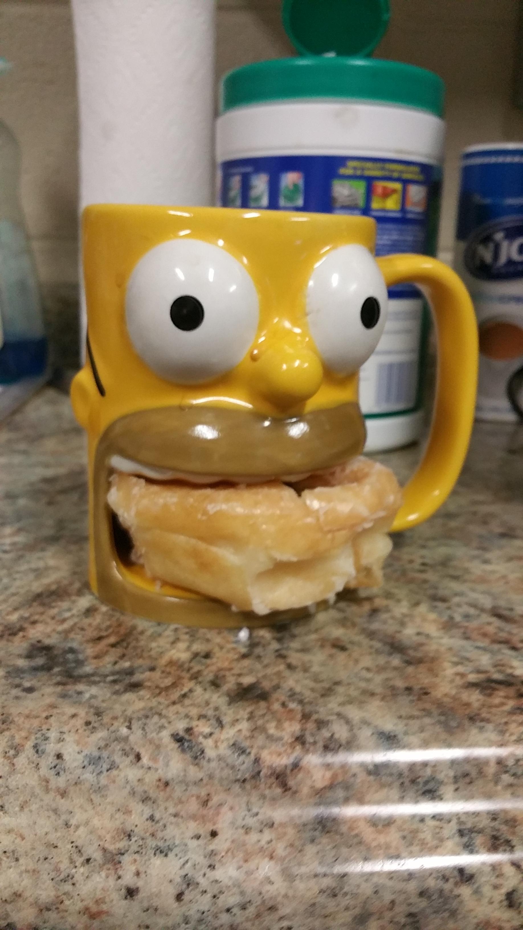 My coworker’s coffee mug holds a donut.