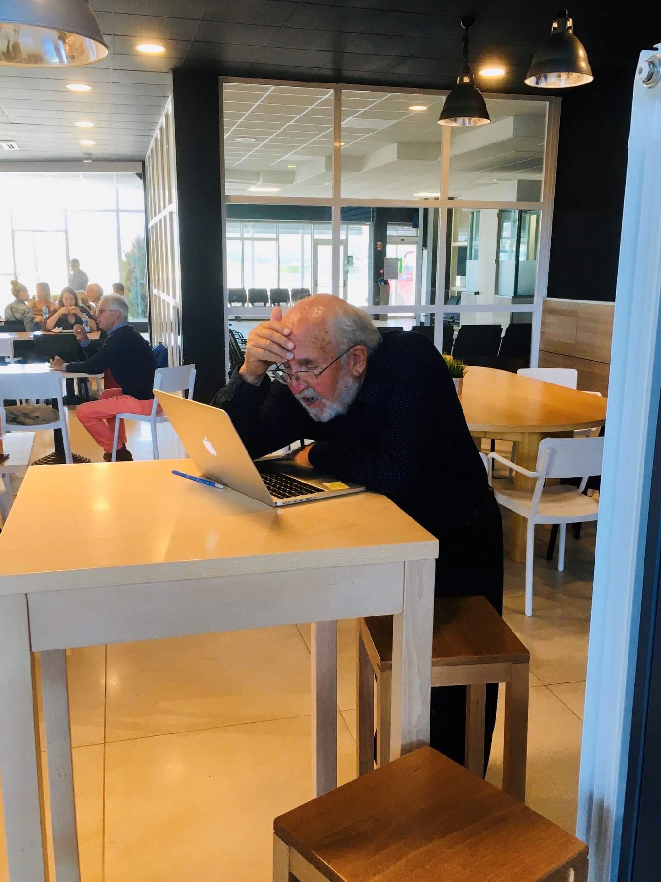 New laureate Michel Mayor was on a lecture tour in Spain when he heard the news about his Nobel Prize in Physics. Here Mayor is in the cafeteria of San Sebastian airport, looking at all the messages f