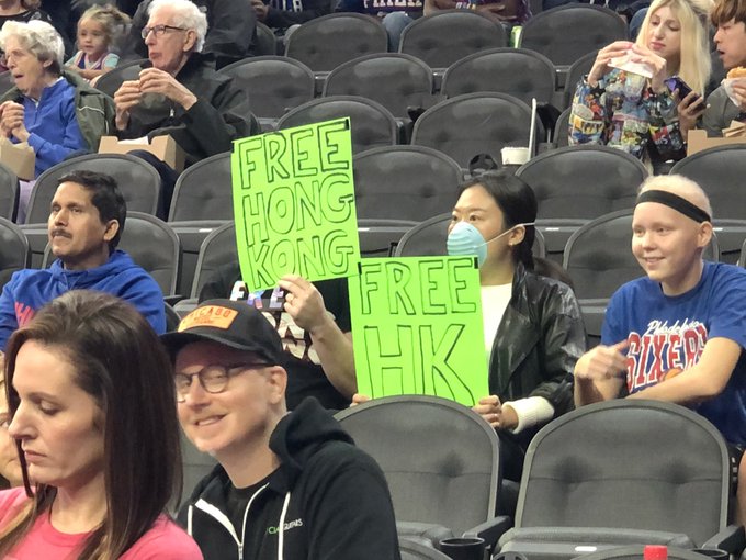 A pair of fans holding “Free Hong Kong” signs were booted from a Philadelphia 76ers game against Chinese squad Guangzhou Loong Lions Tuesday night